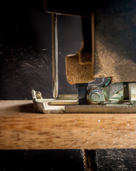 Close up electric jigsaw cutting a piece of wood,action shot