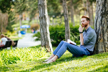 Naklejka na ściany i meble College student studying in park