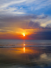 Naklejka na ściany i meble Beautiful sunset sky with reflection at Kuta beach, Bali