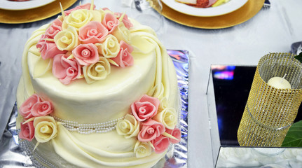 white wedding cake and pink flowers on top