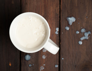 Glass of milk on rustic wooden background