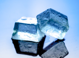 Ice cubes on reflected glass background,blue background