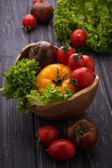 Colorful tomatoes on black background