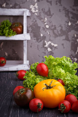 Colorful tomatoes on black background