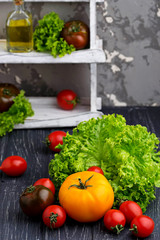 Fototapeta na wymiar Colorful tomatoes on black background