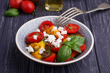 Colorful tomatoes salad with feta cheese