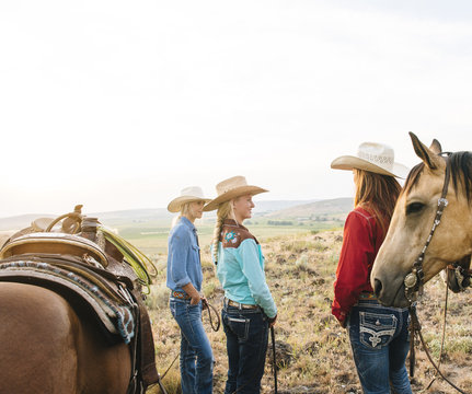Cowgirls with horses on ranch