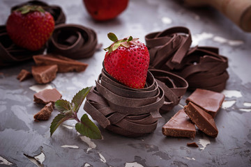 Uncooked chocolate pasta and strawberry