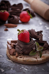 Uncooked chocolate pasta and strawberry