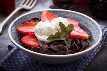 Chocolate pasta with ice cream and strawberry