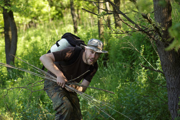 Male tourist gathers dry brushwoods for the fire