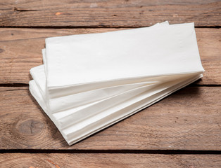 White Paper Napkins on old wooden table.