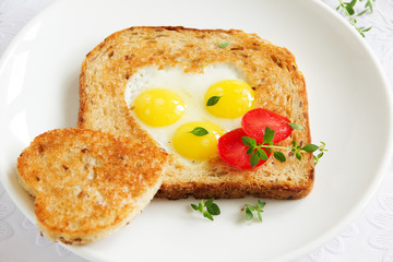 Toast with quail eggs. Snack on Valentine's Day.