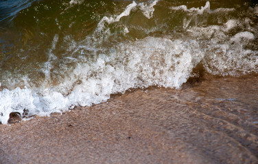 Wave of blue ocean on sandy beach