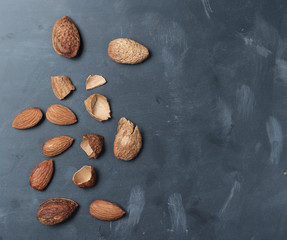 Almonds on a black slate background,