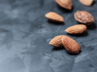 Almonds on a black slate background,