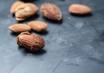 Almonds on a black slate background,