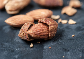 Almonds on a black slate background,