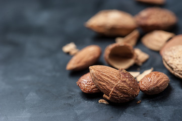 Almonds on a black slate background,