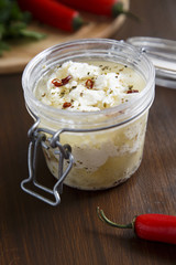 Preserved feta cheese in olive oil with chili and herbs