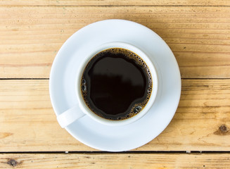 Coffee cup on wooden table background