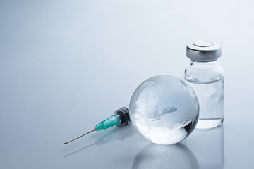 Global healthcare. Globe medical ampules and syringe on white ba
