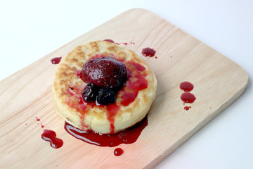 English Crumpets & Berry Topping on wood board isolate on white background