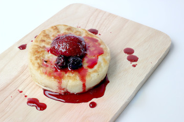English Crumpets & Berry Topping on wood board isolate on white background