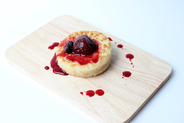 English Crumpets & Berry Topping on wood board isolate on white background