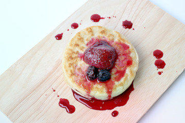 English Crumpets & Berry Topping on wood board isolate on white background
