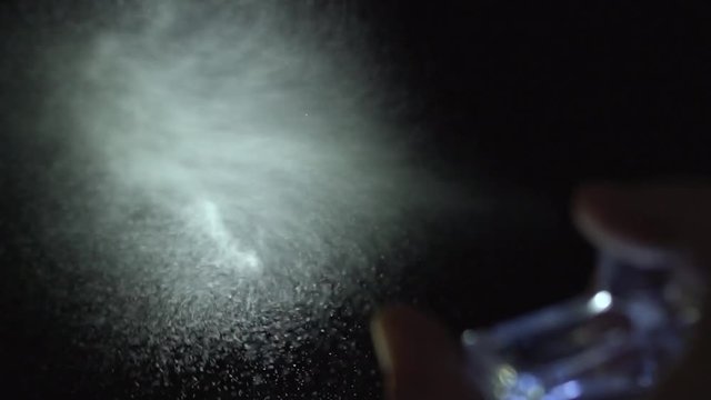 Perfume spray on black background