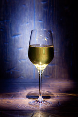 Wine glass on blue wooden background