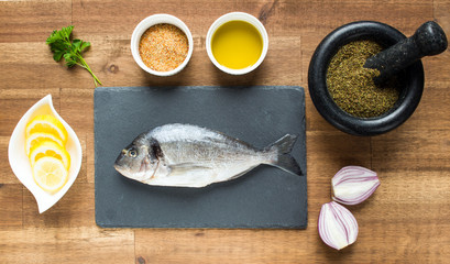 fresh raw dorado fish with spices on white background, top view, square image