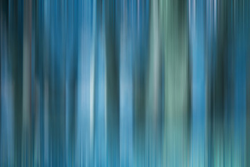 Obraz premium Abstract art for background use. An image of a forest processed with a motion blur effect. The color tone is blue.