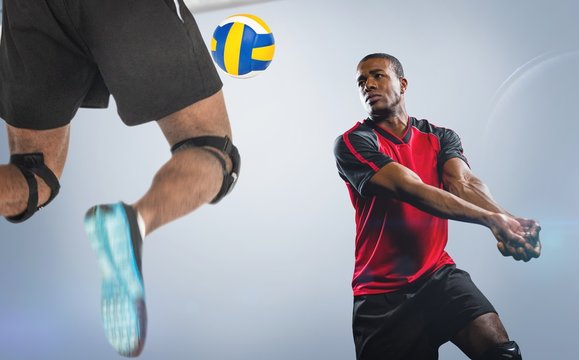 Composite image of rear view of sportsman posing while playing volleyball