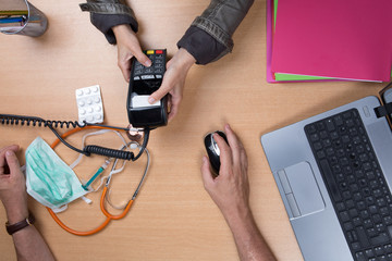 Woman paying the doctor with credit card flat lay