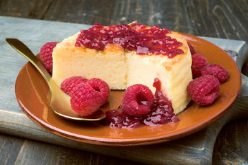 cheesecake with jam on wooden table