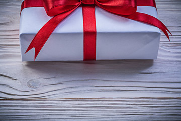 Gift box on wooden board front view holidays concept