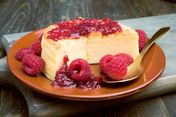 cheesecake with jam on wooden table