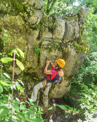 Frau klettert im Klettersteig