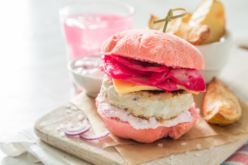 Pink chicken grill burger on wood background