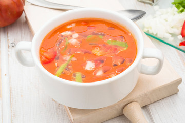 gazpacho soup with oil in white bowl