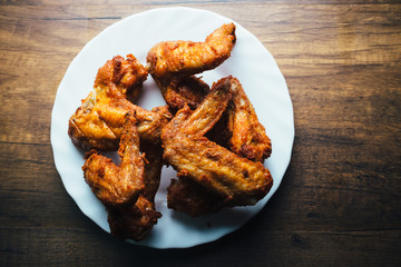 Top View of Fresh fried chicken on a white plate set on a wood table - Still Life Photography