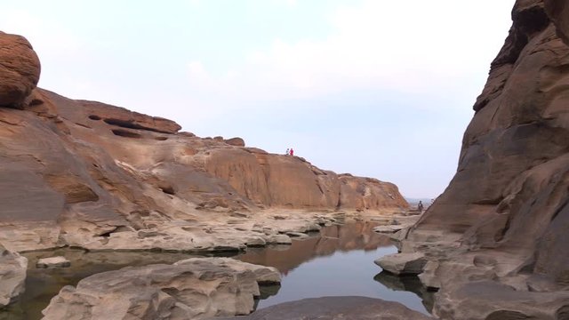 Ubon Ratchathani, Thailand 23 April 2016: Tourists visiting Sam Phan Bok Grand Stone Ubon Ratchathani, Thailand Grand Canyon's natural beauty in the mekong river at low tide.4k