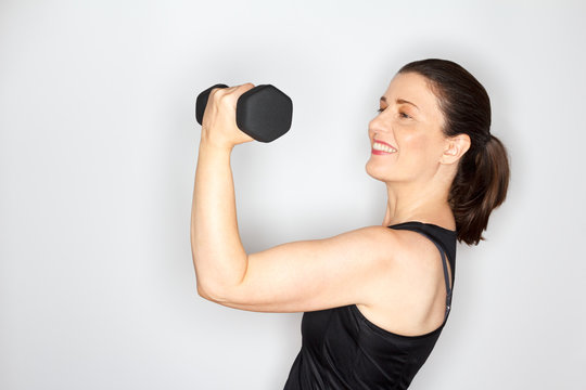 middle aged woman lifting weights