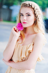 Beautiful woman portrait holding delicate pink rose