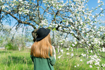 Beautiful hipster girl in spring garden.