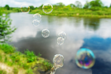 Soap bubbles against the beautiful lake.