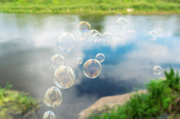 Soap bubbles against the beautiful lake.