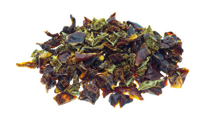 Portion of chopped and dried red and green bell peppers isolated on a white background side view.